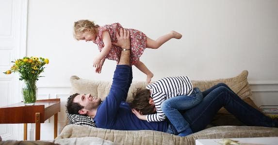 How to save for retirement while you save for the kids' college Dad playing with children | Catherine Delahaye/Getty Images