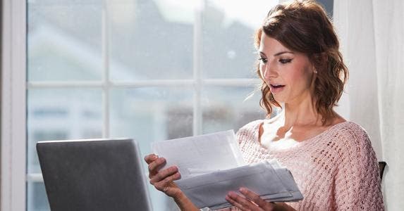 Woman shocked with bills © iStock