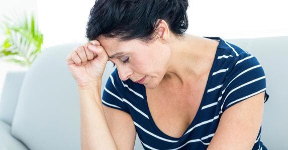 How to build your credit in case of divorce Sad woman sitting on couch | iStock.com