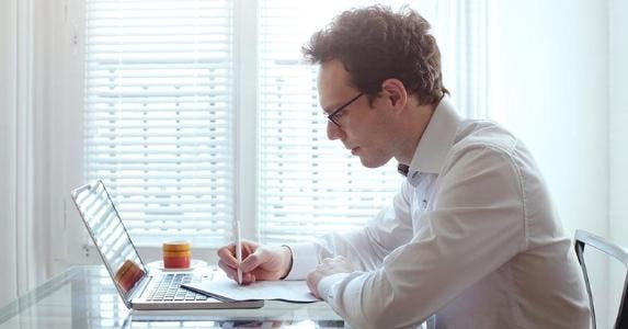 10 trusty tips for taking out personal loans in 2016 Young man working from home on his laptop © iStock