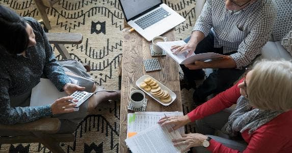 4 ways to tell if your financial adviser is following the new rules Adviser meeting with two clients at home | Hero Images/Getty Images