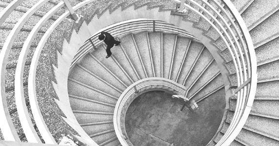 Rising rate CDs don't have a lot of upside Businessman climbing spiral stairs | Evelyne Sieber / EyeEm/Getty Images