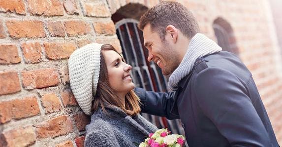 Bankrate survey finds the high cost of love Smiling couple leaning to each other | Kamil Macniak/Shutterstock.com