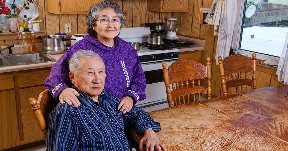 Is my Social Security at risk over VA loan? Senior couple sitting in kitchen | Kevin Smith/Getty Images