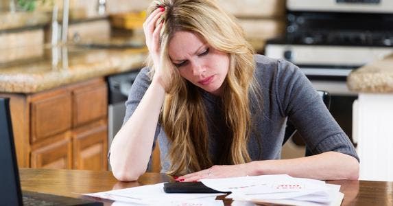 Woman stressed by bills © iStock