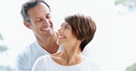 3 reasons why couples should not retire at the same time A couple smiling at each other © iStock