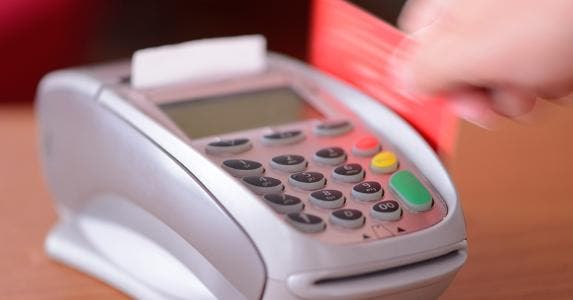 Red card being swiped through machine © iStock