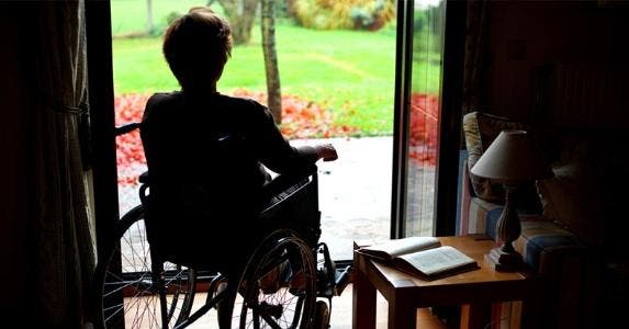 How can I live after widow's benefits disappear? Senior woman in wheelchair looking out of window © iStock