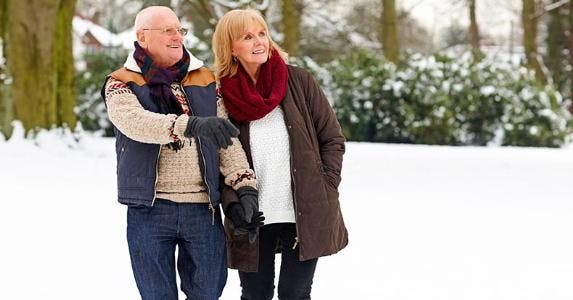 Winter sport retirement spots by the numbers Mature couple walking outdoors in snow © iStock