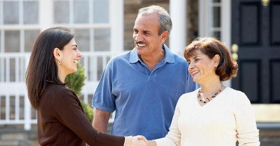 Real estate rules as investing choice, survey says Mature couple shaking hands with real estate agent in front of house | Ariel Skelley/Getty Images
