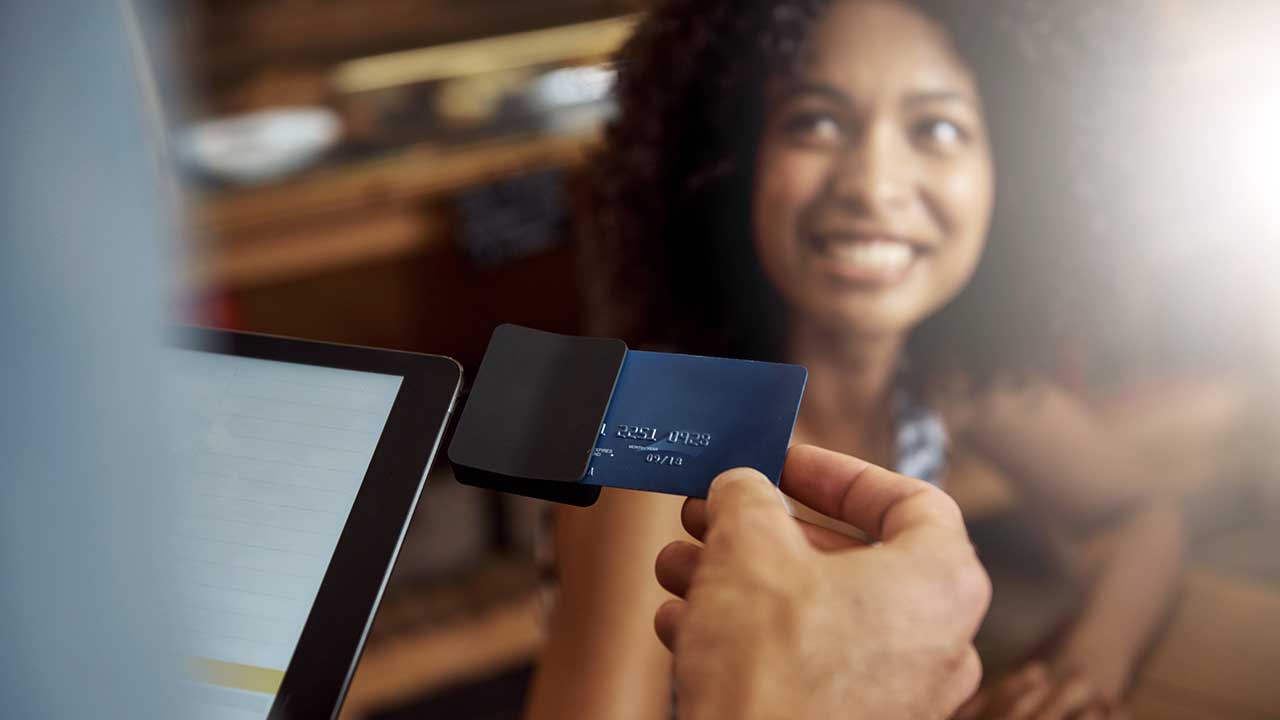 Merchant swiping a woman's charge card