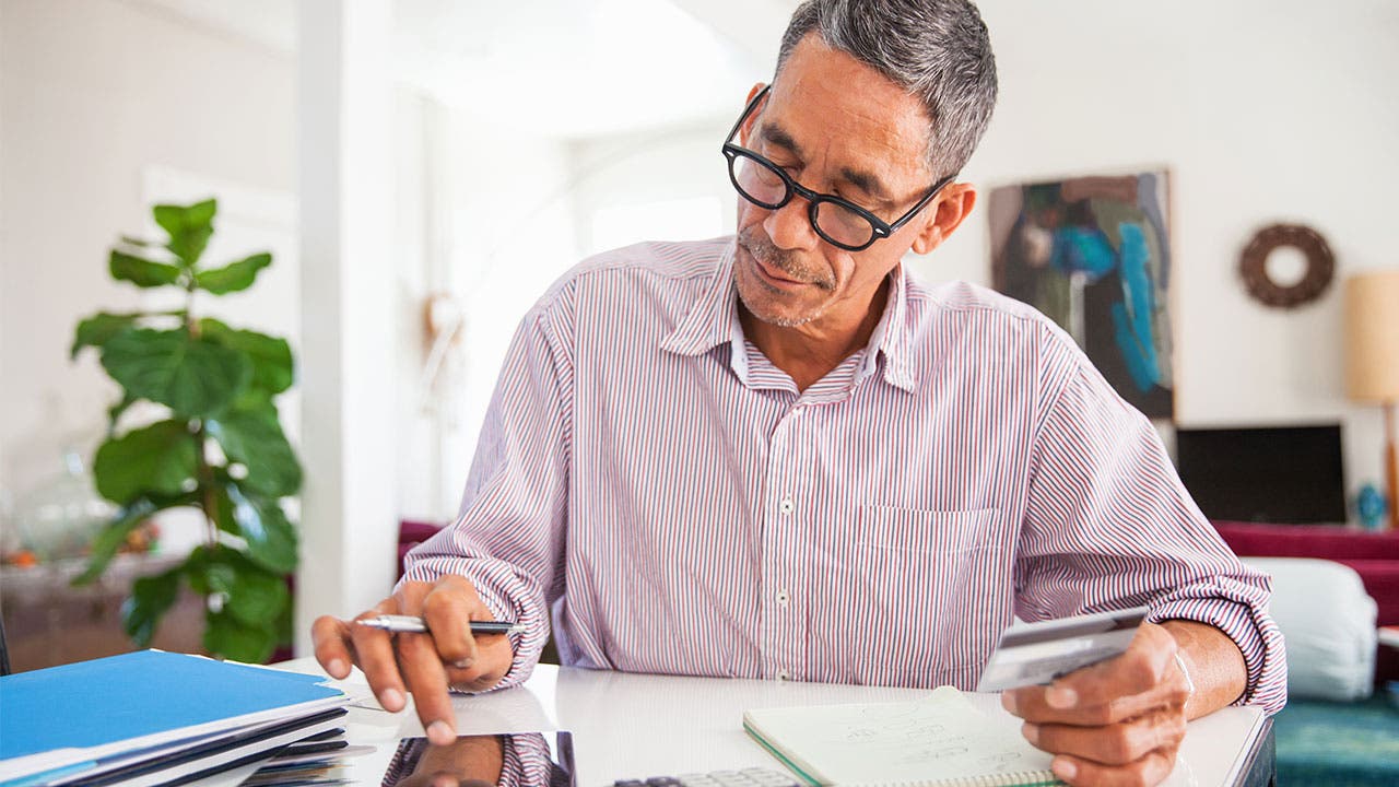 Man doing calculations at desk