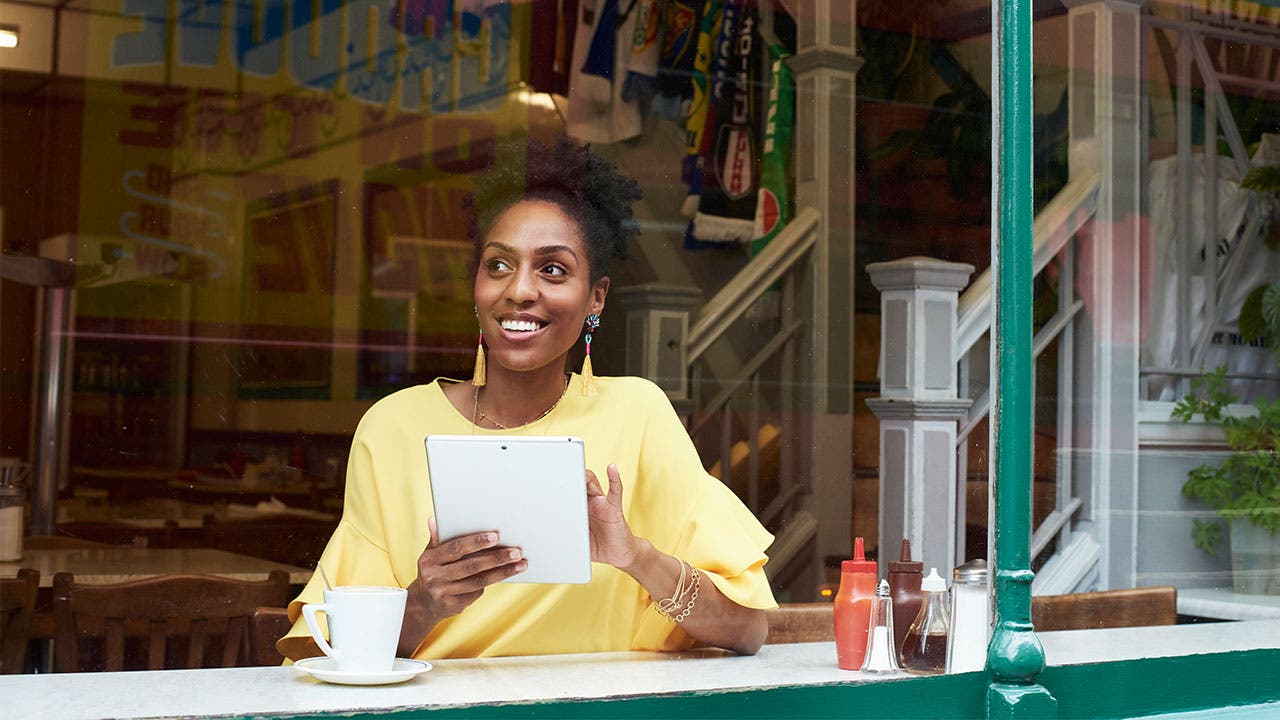 Woman in coffeeshop looking out the window