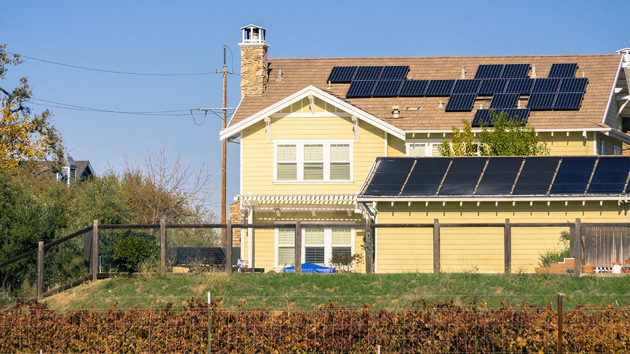 Yellow house with solar panels on roof