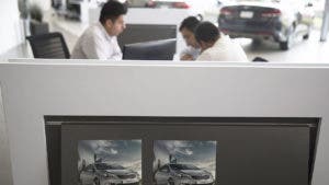 People looking over a car lease