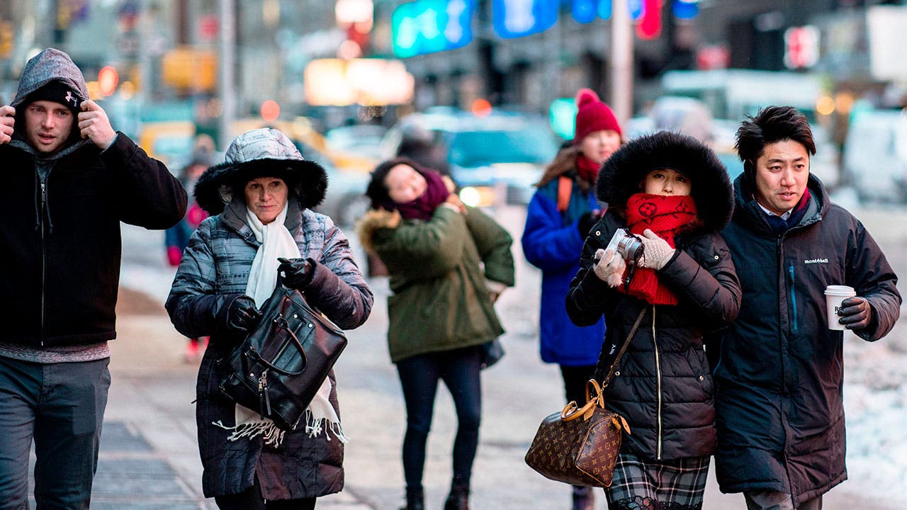 People bundled up walking down the street