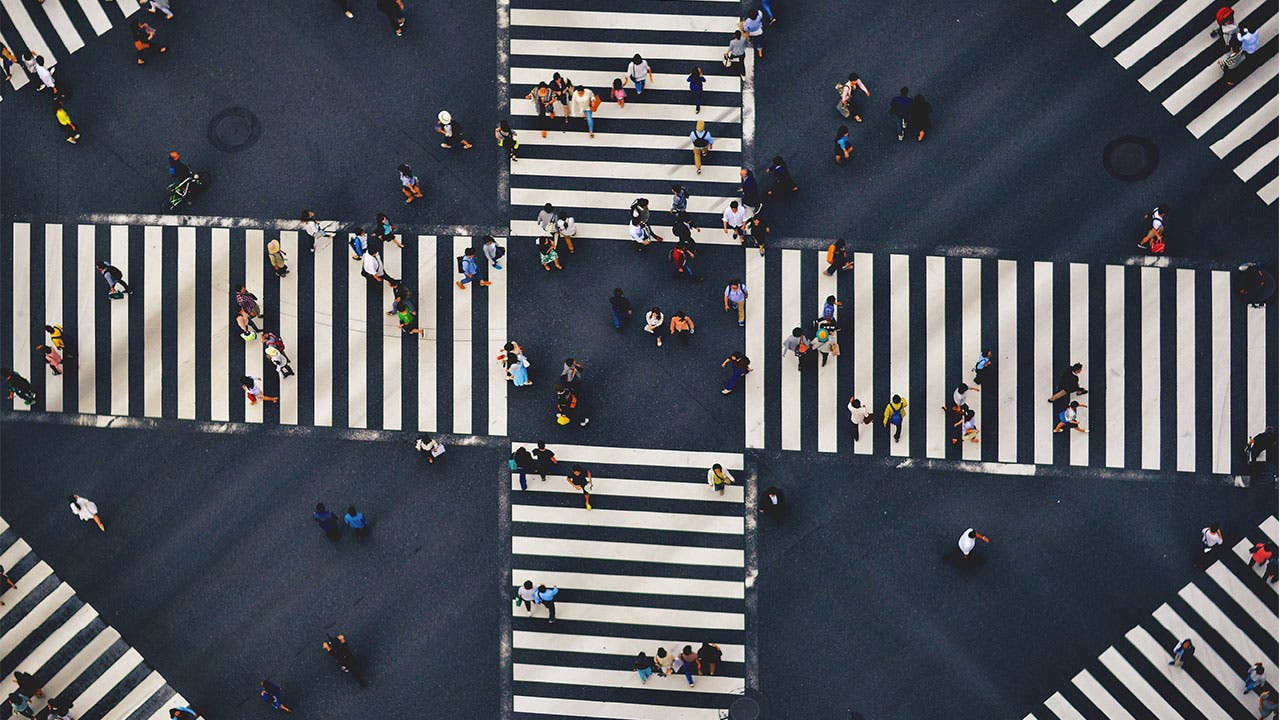 Aerial view of people walking crosswalk