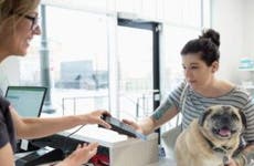 Woman paying with card in vet's office