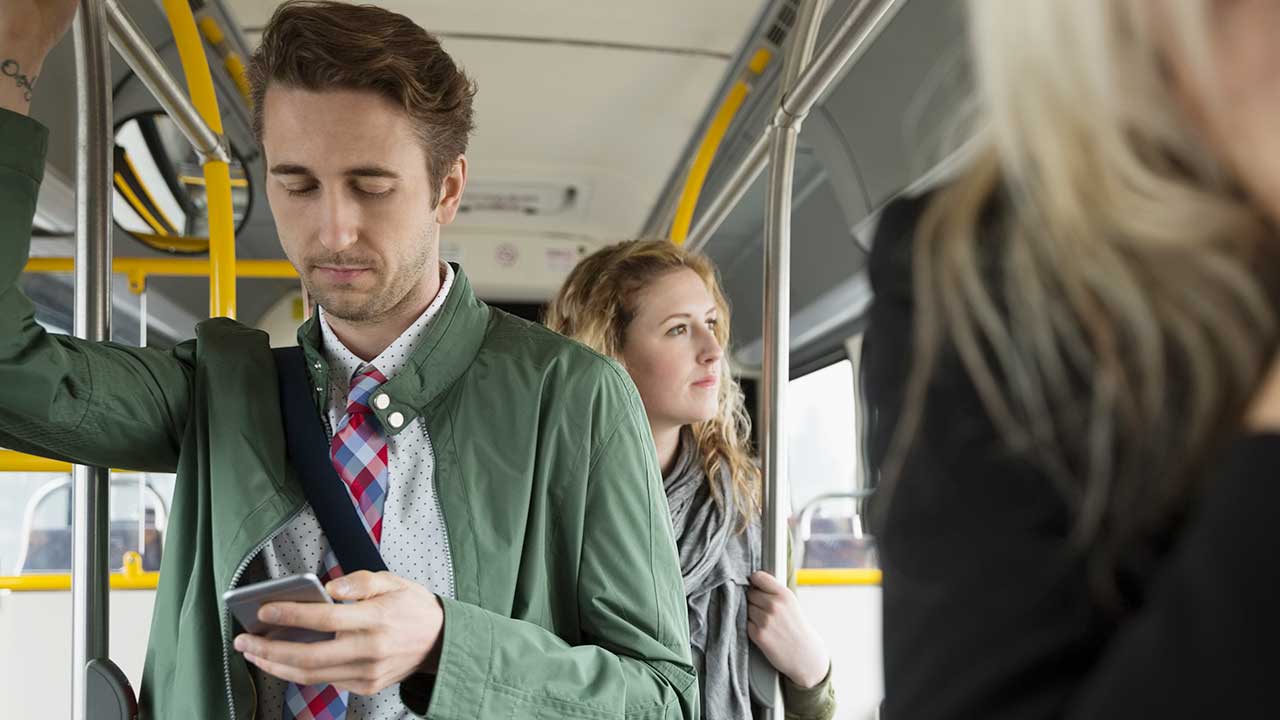 Commuters standing on bus