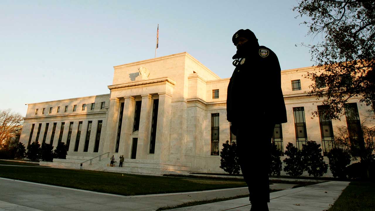 Guard standing in front of Federal Reserve building