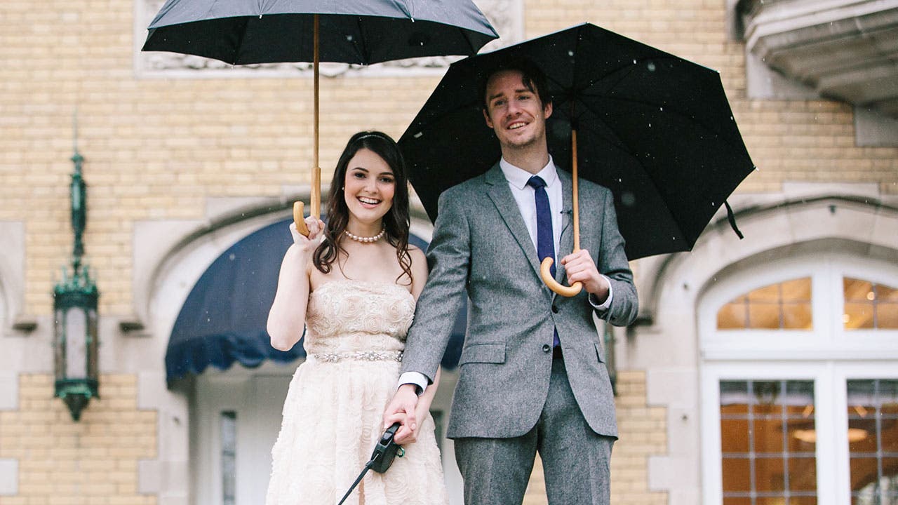 Couple in formal wear with umbrellas