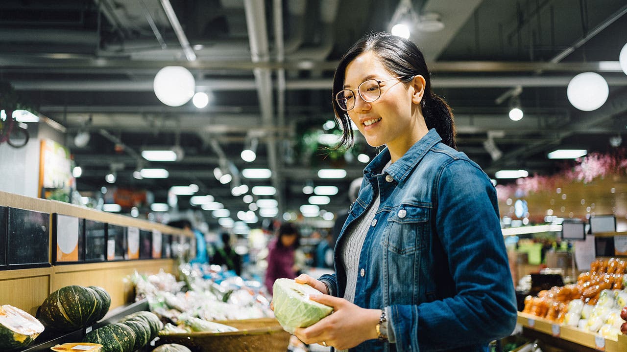 Woman grocery shopping for fruit