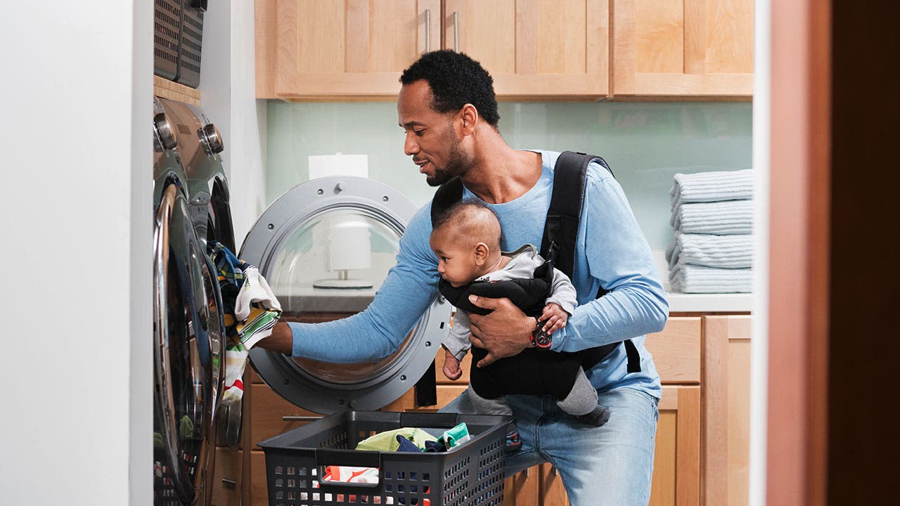 Father doing laundry with son