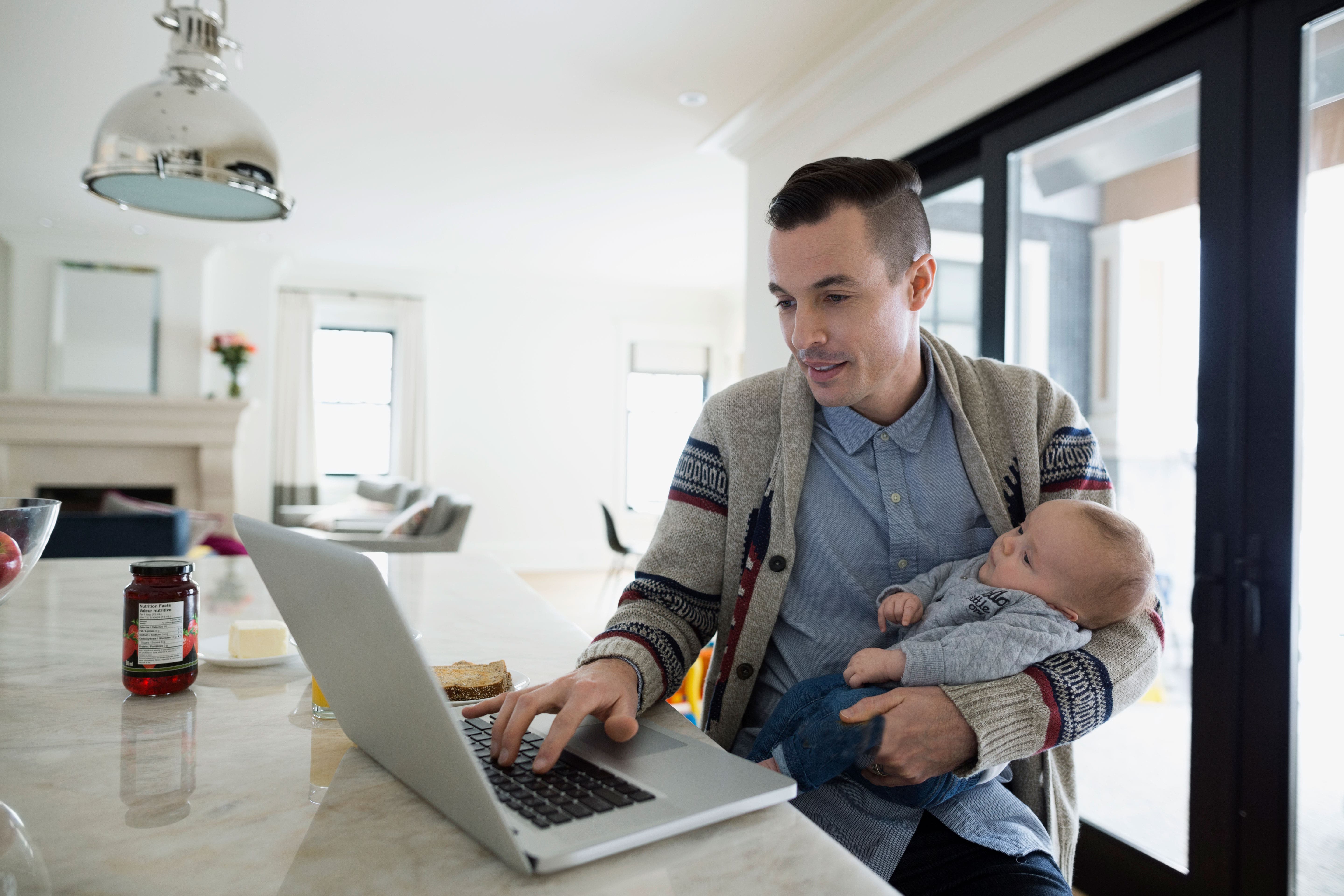 Father looking at computer with son