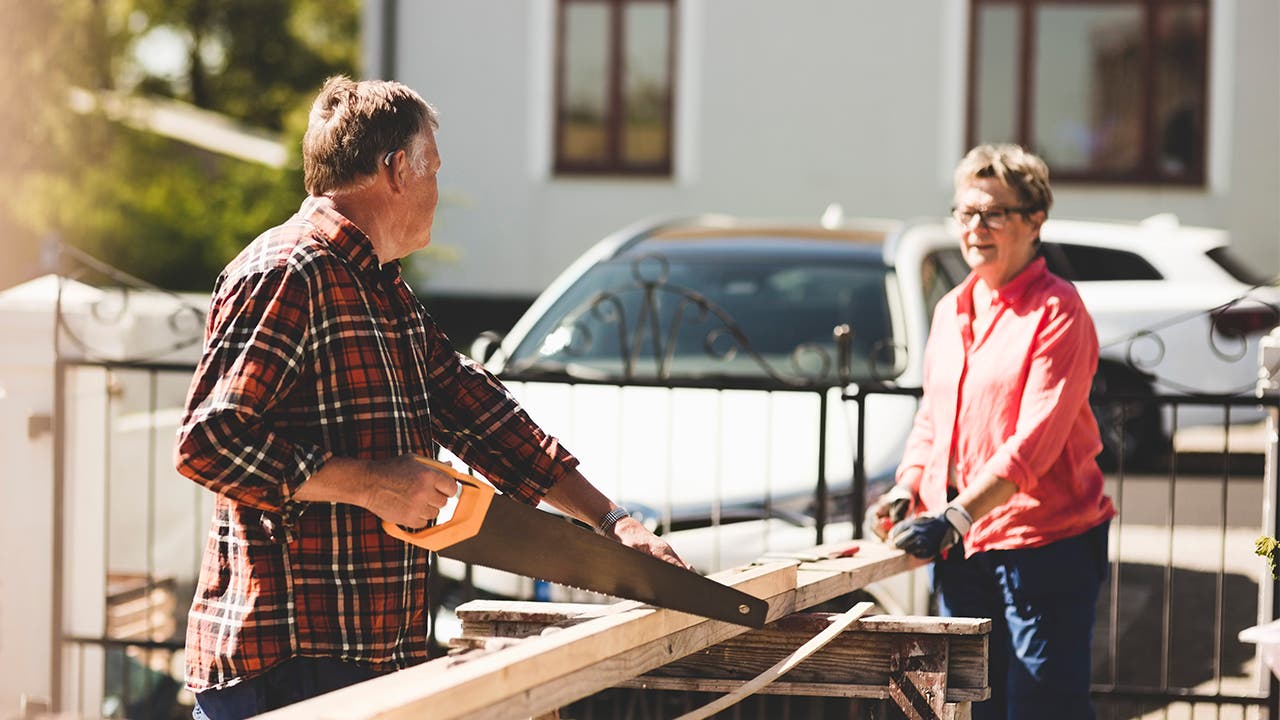 Couple sawing wood