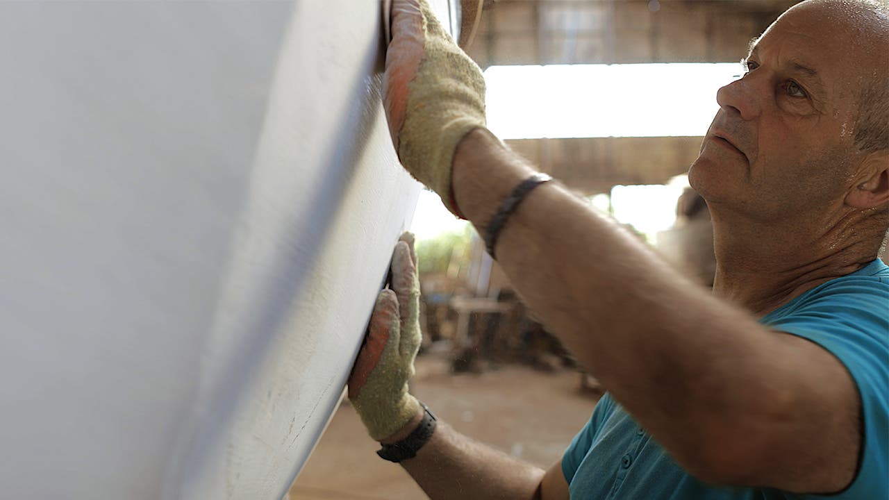 Carpenter inspecting plaster
