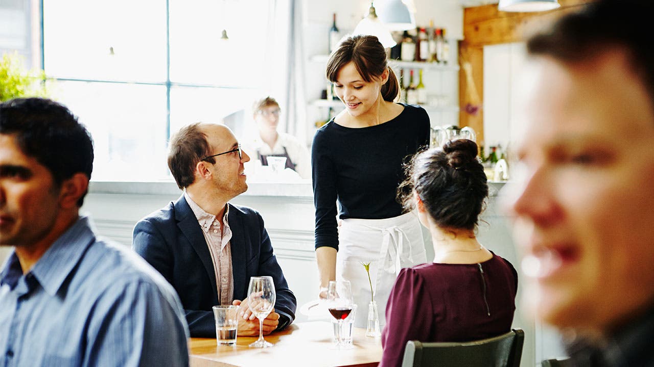 Waitress talks with customers