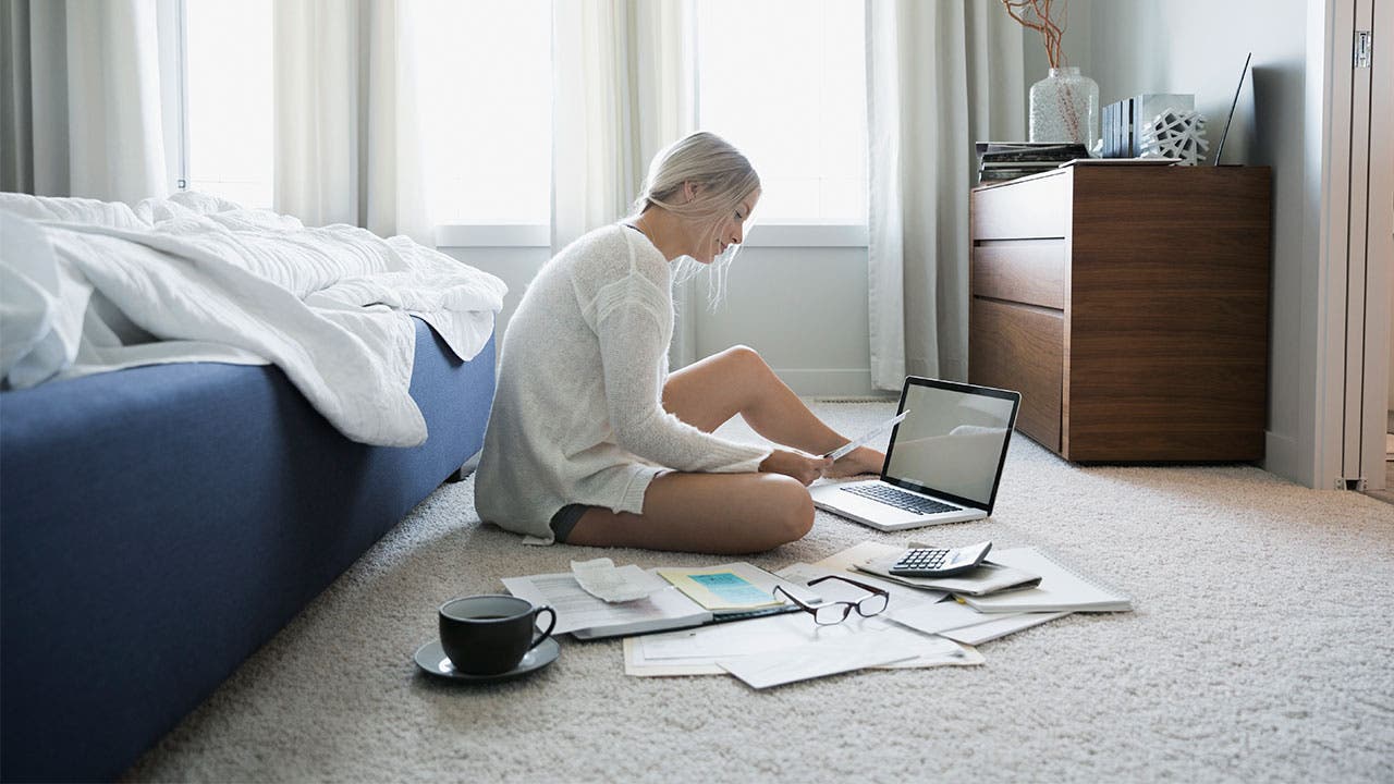 Woman budgeting in bedroom