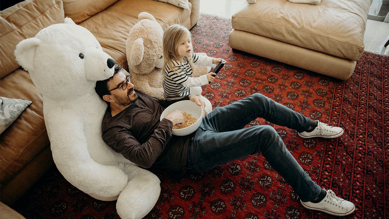 Father and daughter watching television