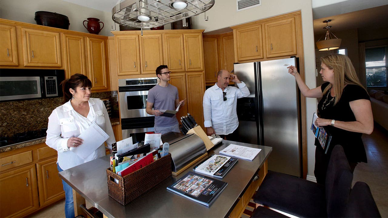 Real estate agent talking with home buyers