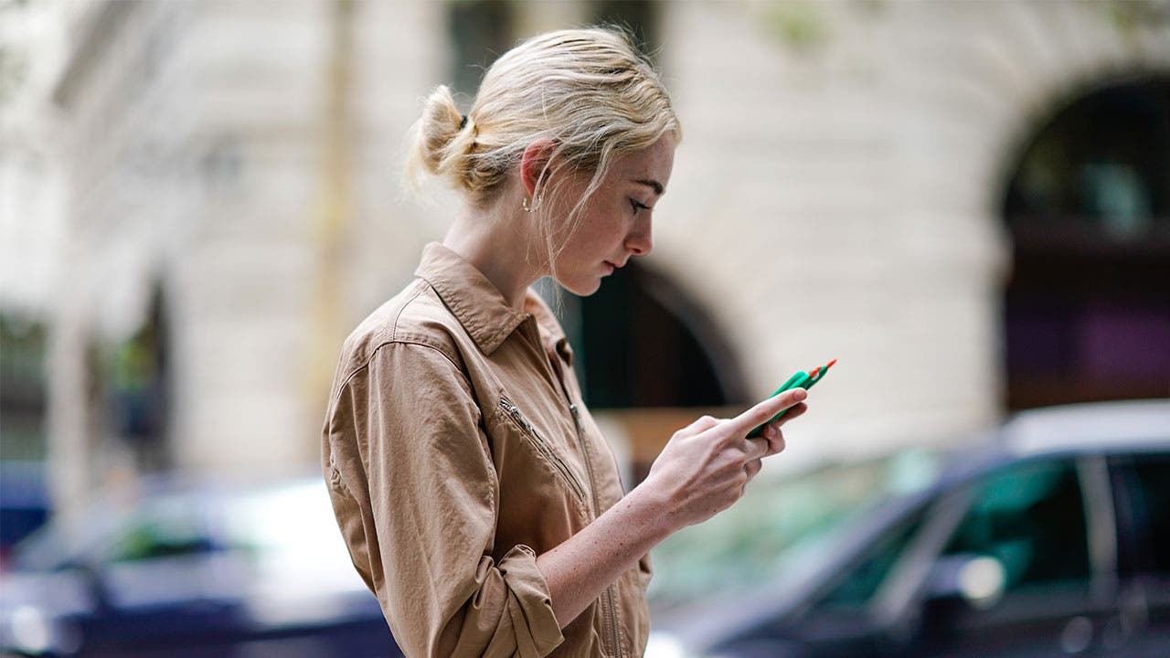 Woman texting on the street