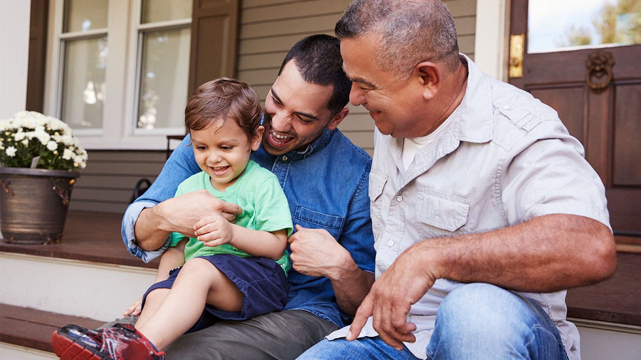 Latino family sitting on stoop