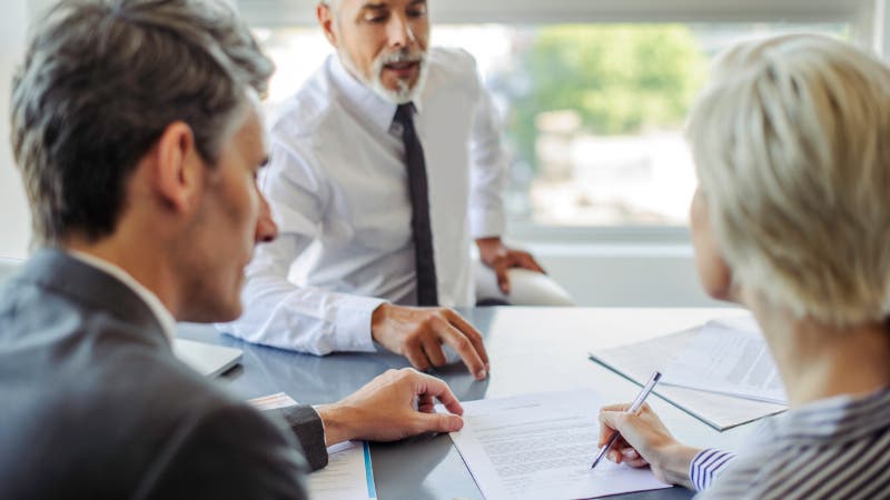 woman signing document in business meeting