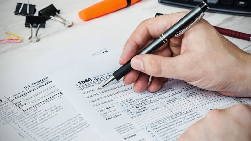 man filing tax form
