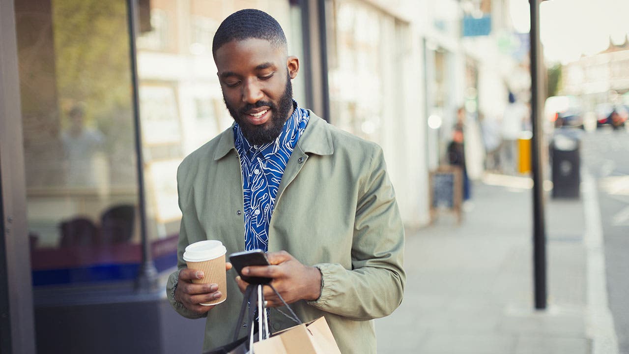 Man uses phone to check credit score