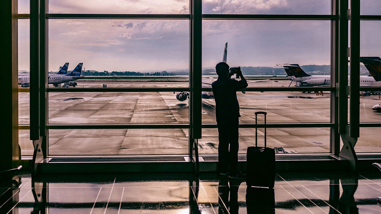 Man taking an picture of plane at airport