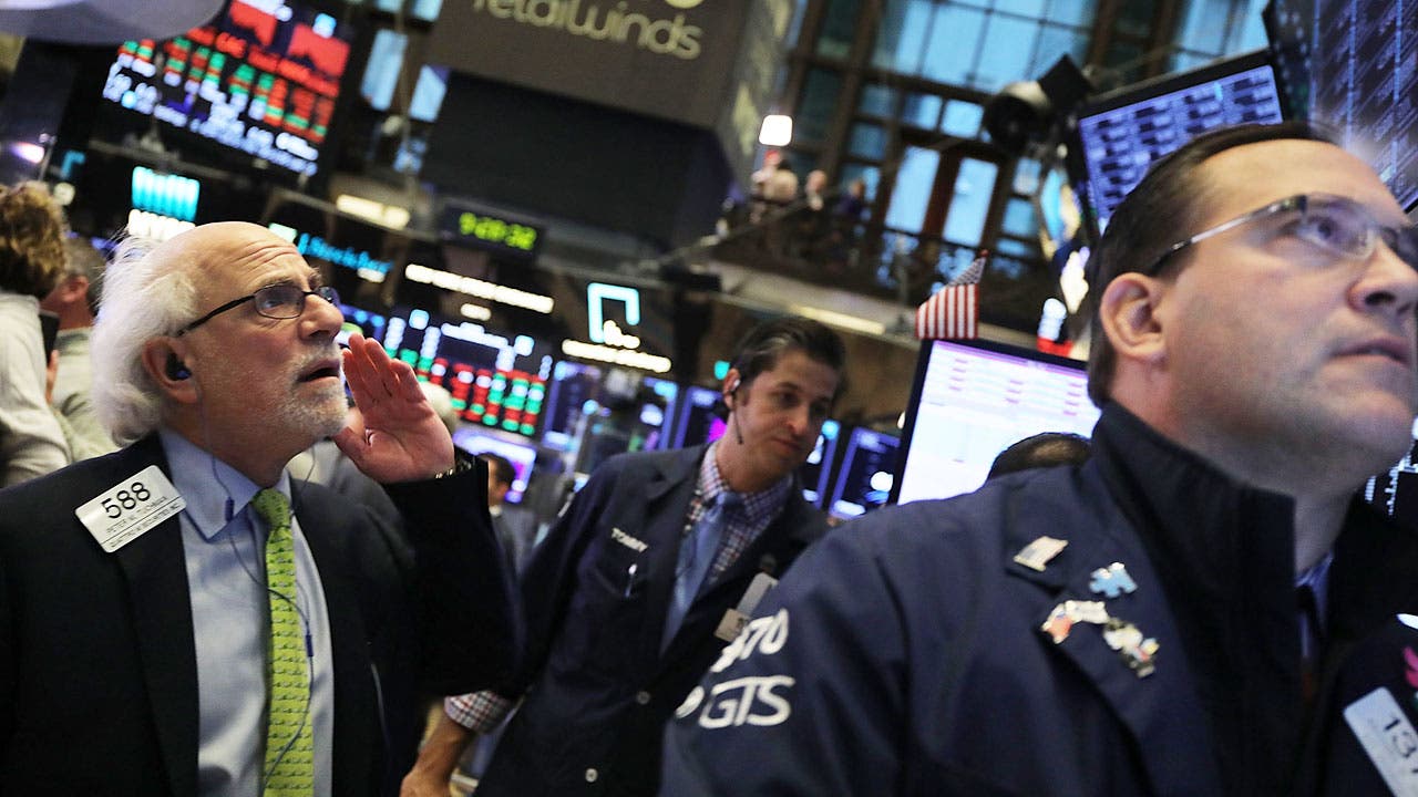Stock brokers on trading floor in New York Stock Exchange