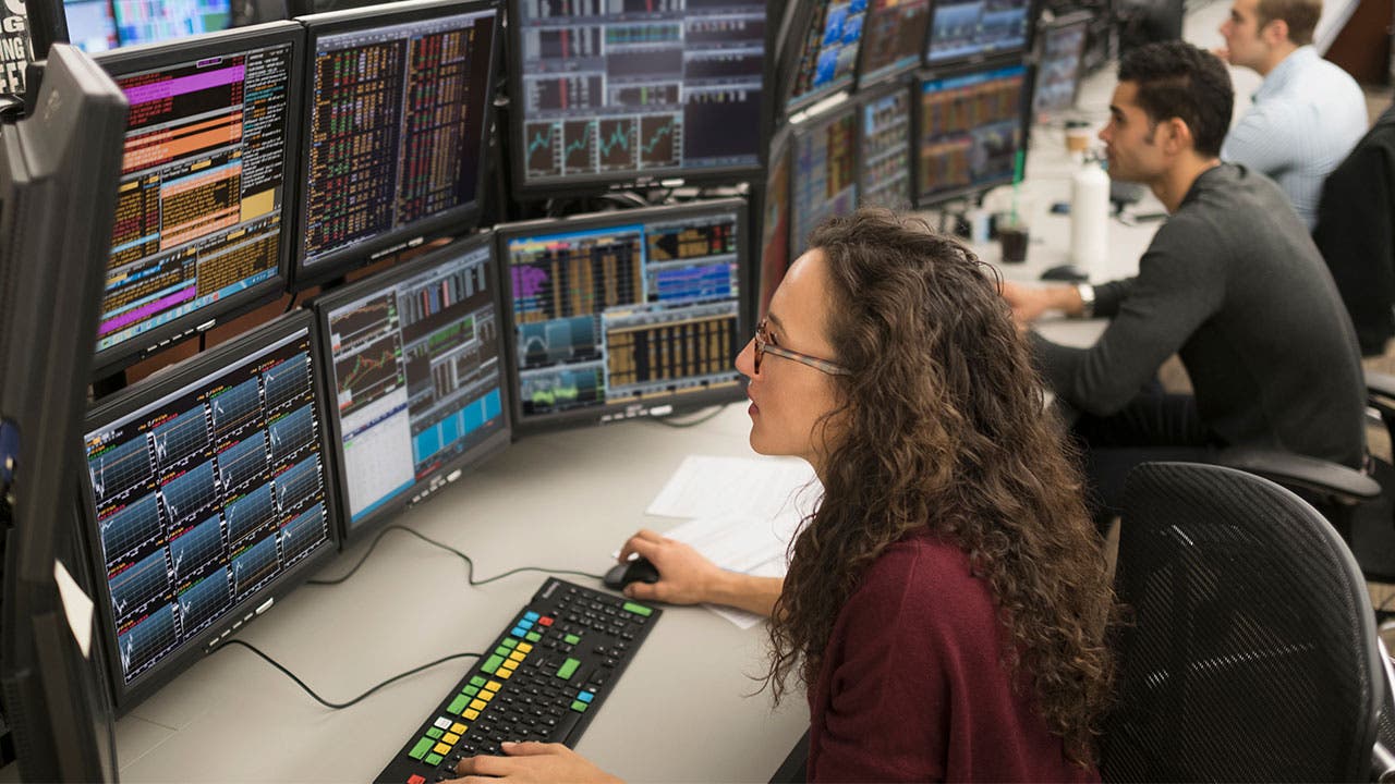 Stock brokers looking at stock trends