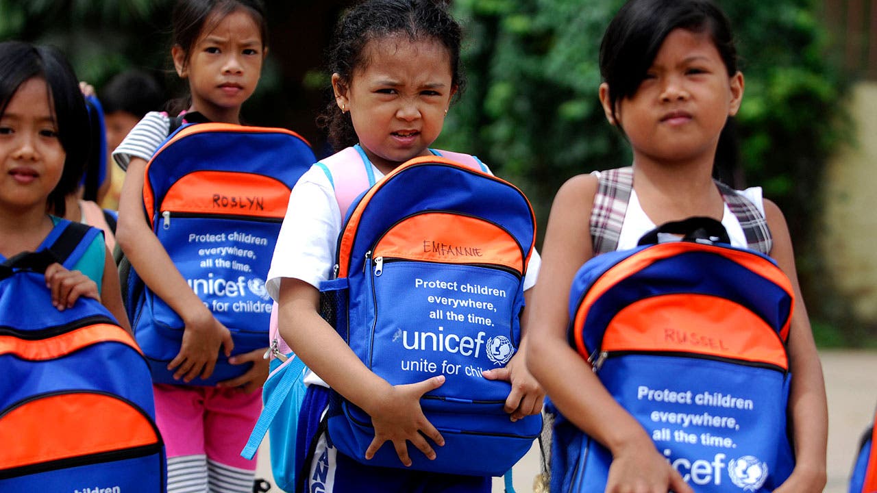 Kids receiving UNICEF backpacks