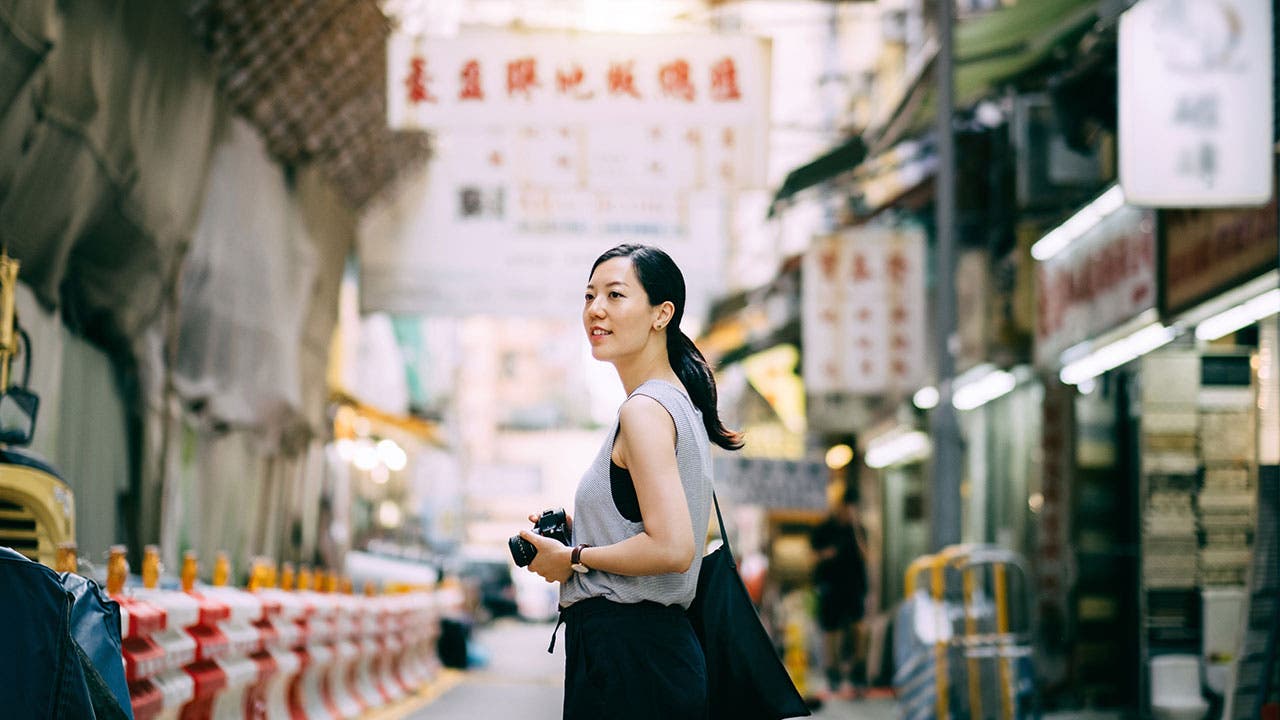 Woman with camera in Asia