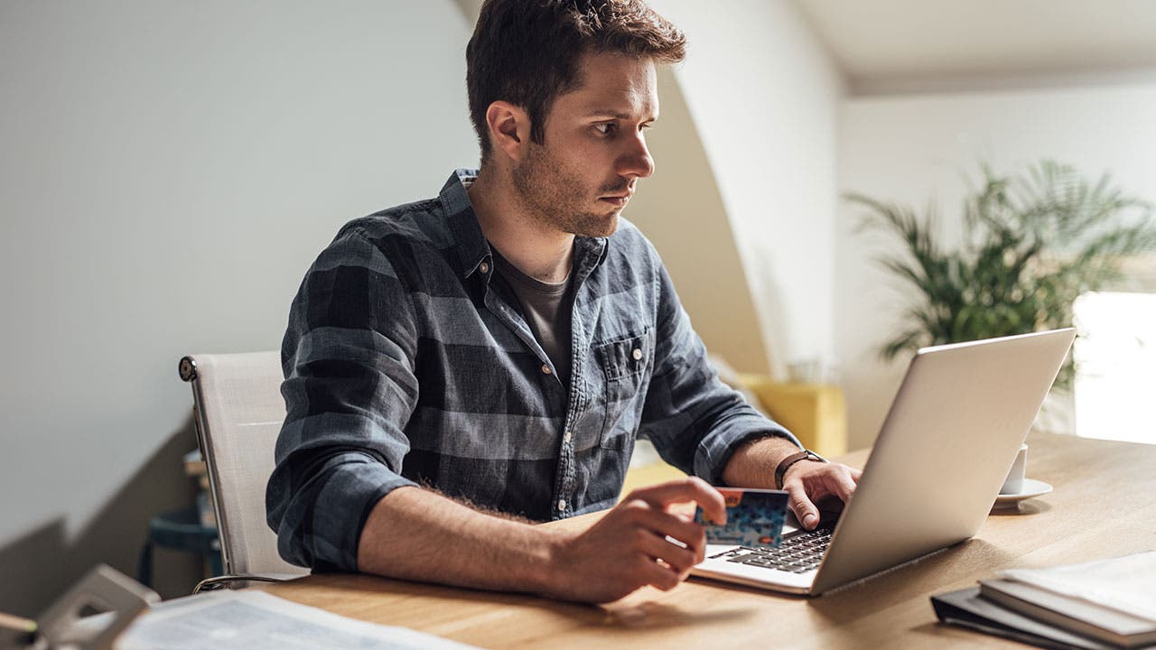 Man using credit card for online purchase