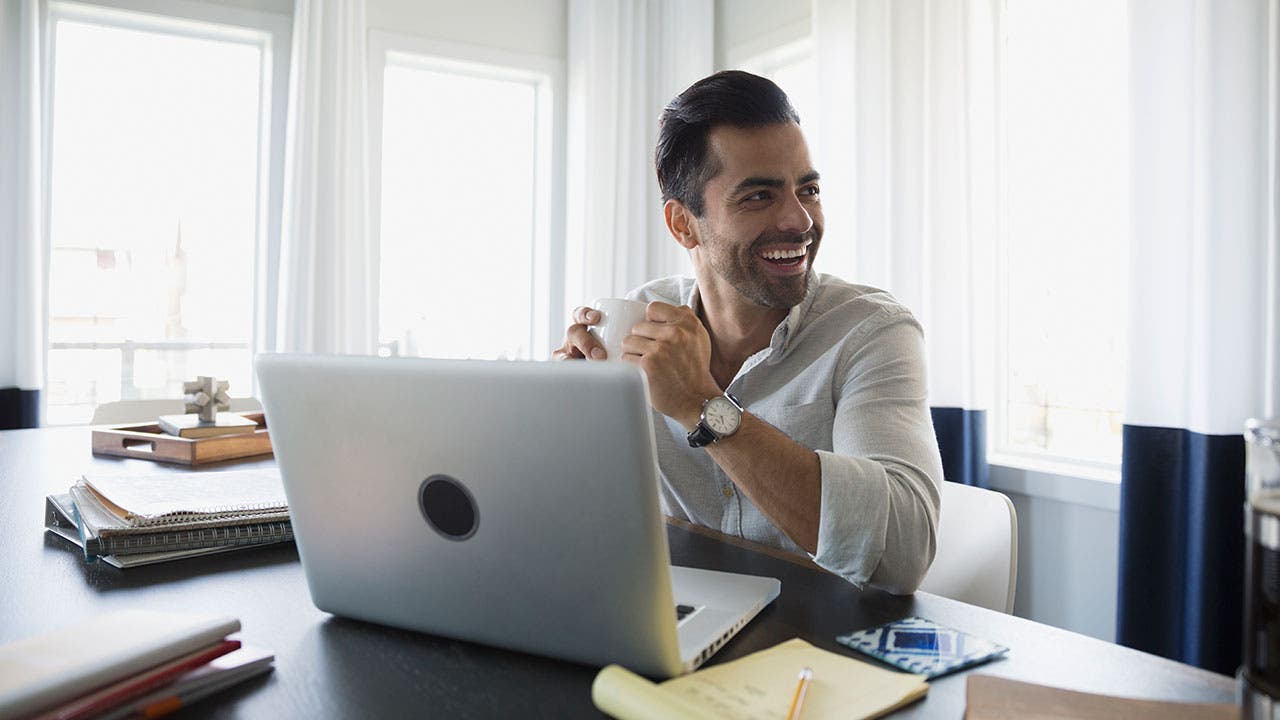 Man at desk smiling