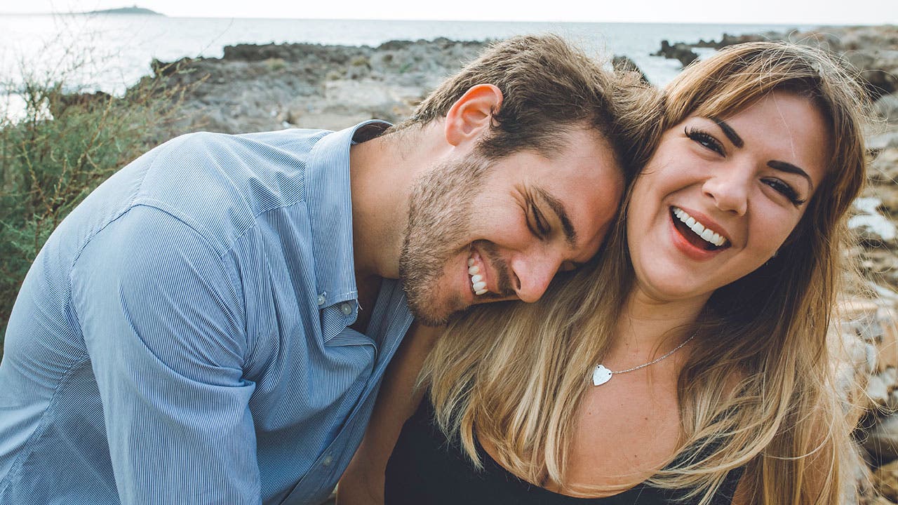 Couple laughing on the beach