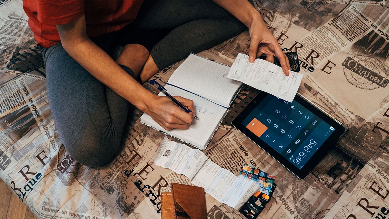 Woman going through credit card receipts at home
