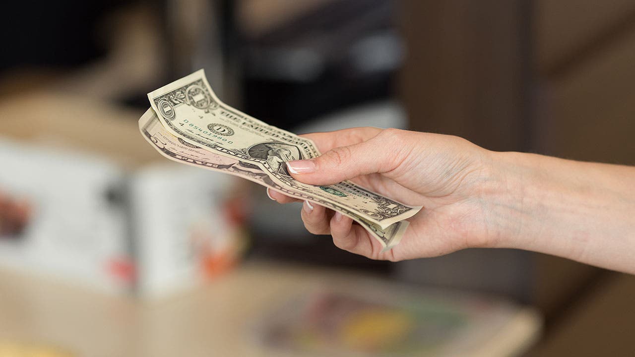 Woman paying with cash