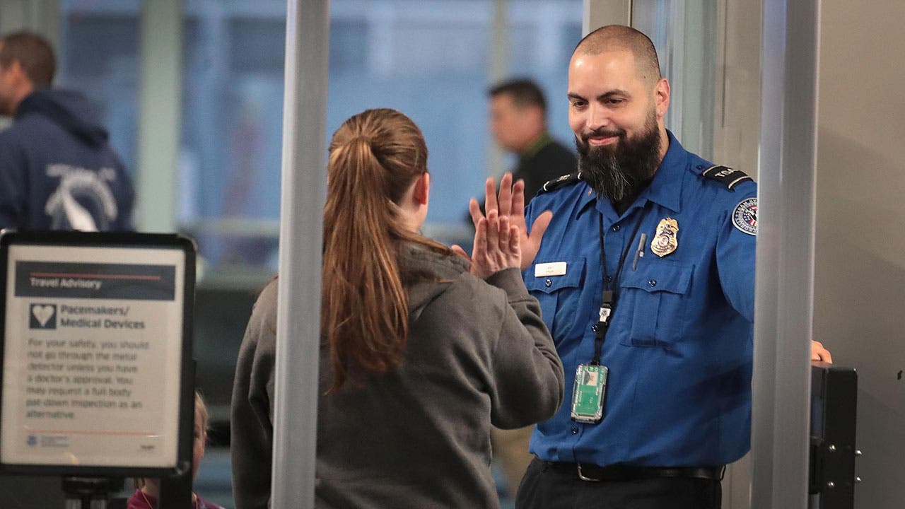 TSA worker high fives traveller